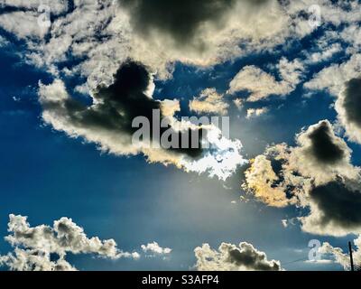 Clouds and sun shining through Stock Photo