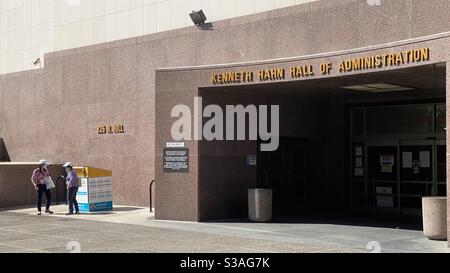 LOS ANGELES, CA, OCT 2020: two women drop off ballots at secure drop box outside county offices in Downtown Stock Photo