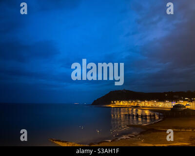 Aberystwyth, West Wales, UK. Monday 19th October 2020. Weather: a stunning bluehour fills the skies and beautiful golden reflections are seen. Photo Credit ©️ Rose Voon / Alamy Live News. Stock Photo