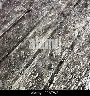 Rainwater collecting on plastic covered café table. Stock Photo