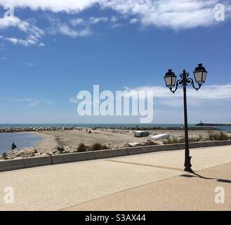Camargue Saintes-Maries-de-la-mer France esplanade with streetlamp and beach Stock Photo