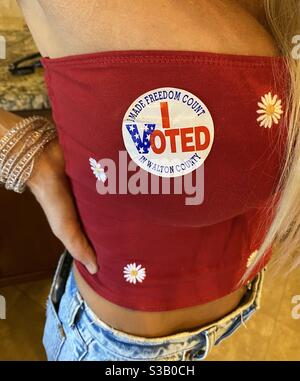 Young woman with I voted sticker on red shirt Stock Photo