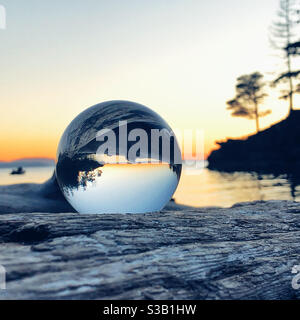 Beach sunset in glass orb Stock Photo