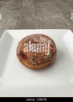 Jam doughnut on a white plate Stock Photo