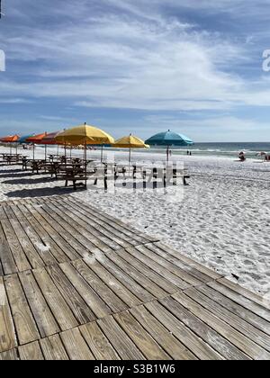 Colorful beach umbrellas and picnic tables on Florida white sand beach Stock Photo
