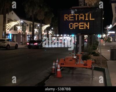 Palm Springs, USA. 13th Nov, 2020. A retail sign early in the night as riverside county moves back to the purple tier after covid-19 infections spike. Stock Photo