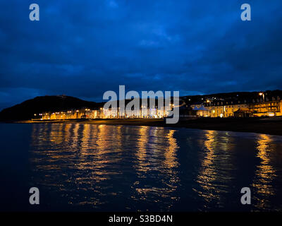 Aberystwyth, West Wales, UK. Monday 23rd November. Weather: A beautiful Bluehour and golden reflections in the sea in Aberystwyth. Photo Credit ©️ Rose Voon / Alamy Live News. Stock Photo