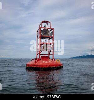 Red bell buoy shipping channel marker Stock Photo
