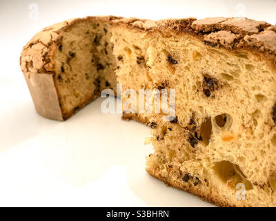 Panettone, classic Christmas Milan dessert with raisins and chocolate , close-up slices isolated on white Stock Photo