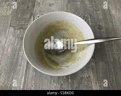 An empty bowl of homemade broccoli soup on a wooden background Stock Photo