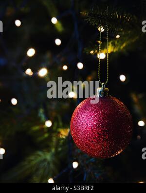 Traditional bauble decoration ornament on a Christmas tree with fairy lights Stock Photo