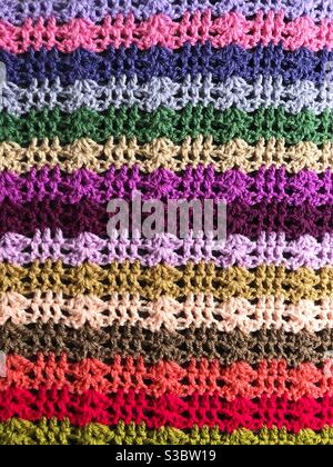 Crochet background of the colourful stitching and crocheting of a beautiful blanket with copy space Stock Photo