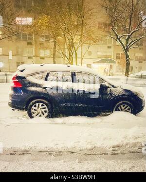 Snow-covered Toyota Prius parked on Park Avenue in New York City Stock Photo