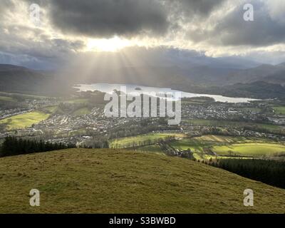 Shot of Keswick from Latrigg with sun bursting onto the ground from the sky Stock Photo