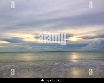 Ocean at the beach with overcast sky Stock Photo