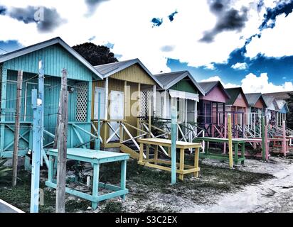 Row of Brightly painted beach huts for vendors to sell from on Long bay beach in Antigua Stock Photo