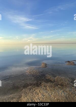 Sunset over the Choctawhatchee bay at low tide with soft pastel skies Stock Photo
