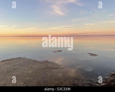 Soft pastel sunset skies over the Choctawhatchee Bay at low tide Stock Photo