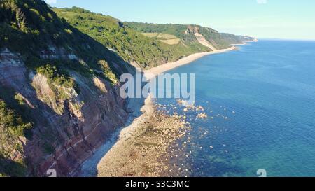 Aerial drone shot of Weston beach, cliffs and sea near Sidmouth, Devon, England on a bright summer day Stock Photo