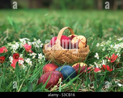Wooden basket filled with colorful Easter eggs Stock Photo