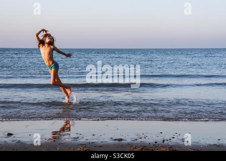 Girl dancing in North Sea Stock Photo