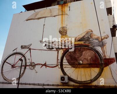 Trishaw man by Ernest Zacharevic street art in Georgetown Penang Malaysia Stock Photo