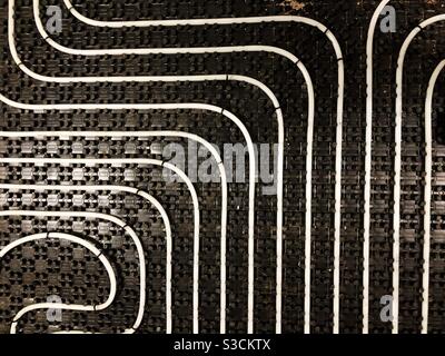 Underfloor heating tubes in a geometric pattern Stock Photo