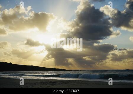Sunbeams from behind clouds looking across smiths beach in Margaret River Western Australia Stock Photo