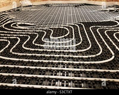 Underfloor heating tubes in a geometric pattern Stock Photo
