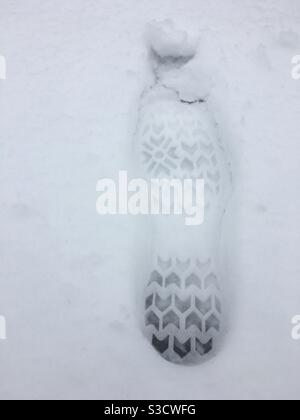 Boot print in the snow, London, UK. Stock Photo