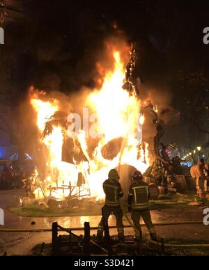 Two fireman putting out a fire at Fallas - a festival in Valencia, Spain Stock Photo