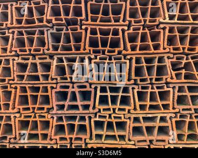 Stack of old clay hollow bricks Stock Photo