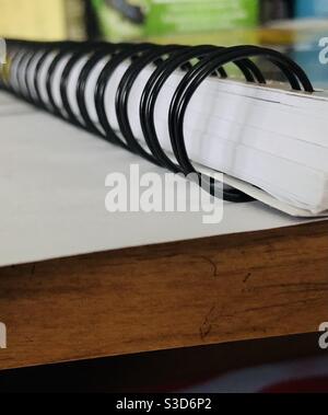 Spiral notebook on a desk, closeup abstract. Stock Photo