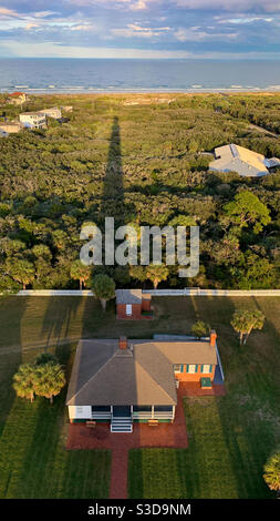 Shadow of the Ponce de Leon Inlet Lighthouse and light keepers house near Daytona Beach, Florida. Stock Photo
