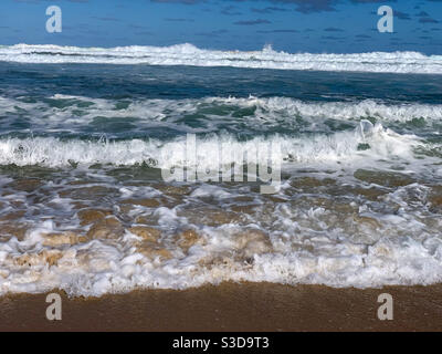 Gentle waves rolling in to shore Stock Photo