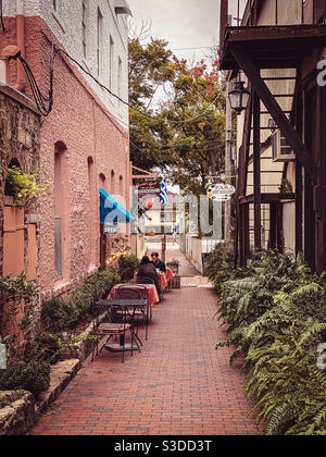 Cafe seating on Artillery Lane between Aviles Streer and Charolette Street in the St. Augustine, Florida Historic District. Stock Photo