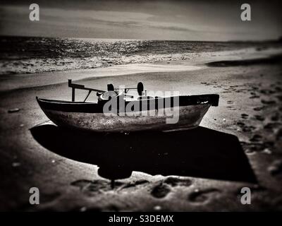 High contrast image of a fishing boat on the shore Stock Photo