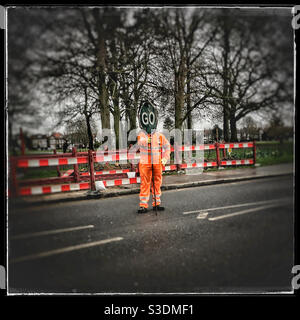Workman holding GO sign Stock Photo