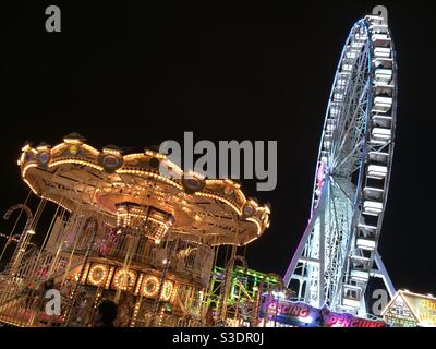 Carousel and Ferris wheel lights at night Stock Photo
