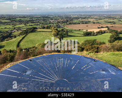 Frocester Hill topograph and view across the Severn Vale countryside. Looking towards the River Severn and Wales in the far distance. From Coaley Peak in the Cotswolds, near Stroud, Gloucestershire. Stock Photo