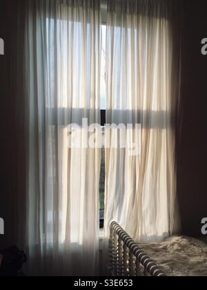 Sunlight streams through a child’s bedroom window in the morning. Stock Photo