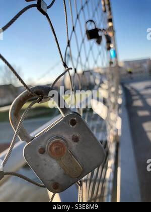 Love locks hanging on a wire fence Stock Photo
