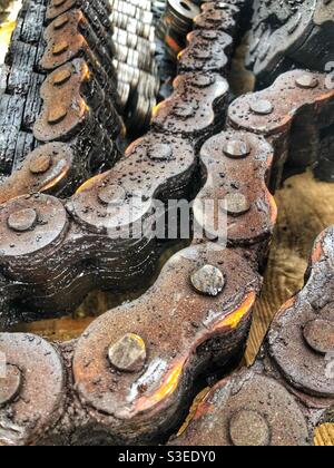 Large links of a heavy industrial metal chain with copy space in a full frame background Stock Photo