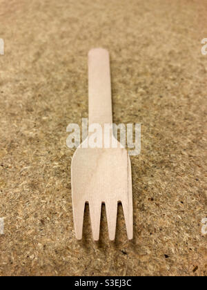 Wooden fork on chipboard background Stock Photo