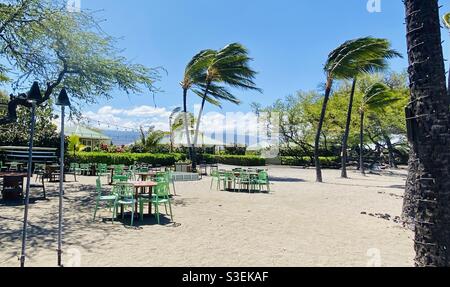 The tables in famous Lava Lava Beach Club in Waikoloa, Hawaii, in the leeward/dry/Kona side of the big island, with private resort cabanas in the background Stock Photo