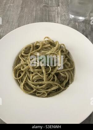 Closeup image of a bowl of linguine pasta with a pesto sauce Stock Photo