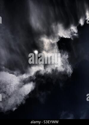 Dramatic cloudscape and the sun appears from behind the clouds Stock Photo