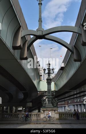 A man on a bicycle crossing the Edo Bridge in Tokyo, Japan Stock Photo