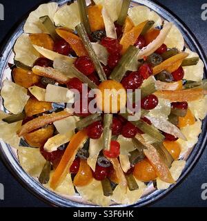 Plate of seasonal dried glacé fruits for Christmas. Stock Photo