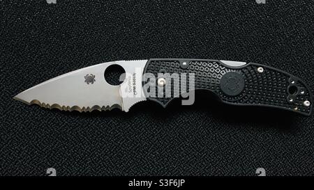 Black Spyperco folder pocket knife on a black background made in USA Stock Photo